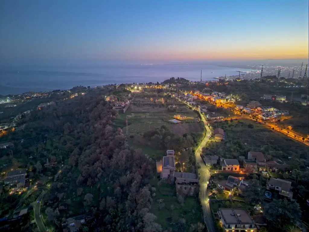 A hill overlooking the bay of Catania in Sicily at night. 7 RAW images merged to HDR taken with a DJI Mini 4 Pro by Vicvideopic